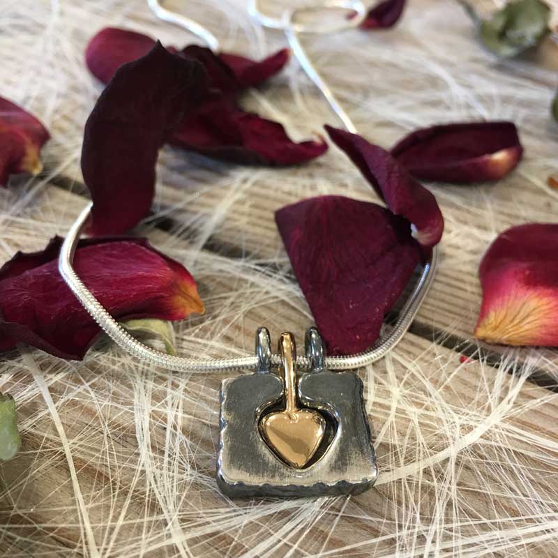 Embrace my heart - HÅLL OM (Embrace) MITT HEART (My heart), 18K gold and 925 sterling silver pendants, handcrafted by GULDVIVA
